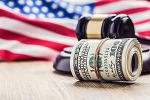 Money and gavel with american flag background