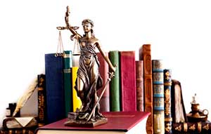 Statue of justice on top of chapter 11 bankruptcy law books