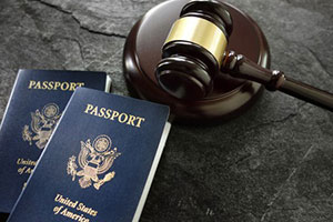Gavel next to passports acquired by h-1b visa
