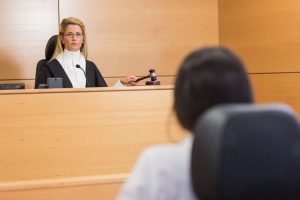 judge who is reading out a forum selection clause to a person who broke their contract