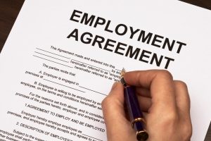 female hands filling out employment agreement contract